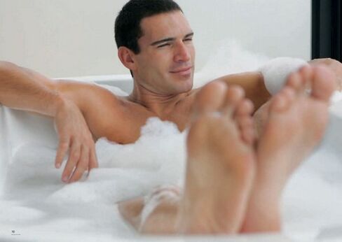 A man takes a bath with baking soda to enlarge his penis